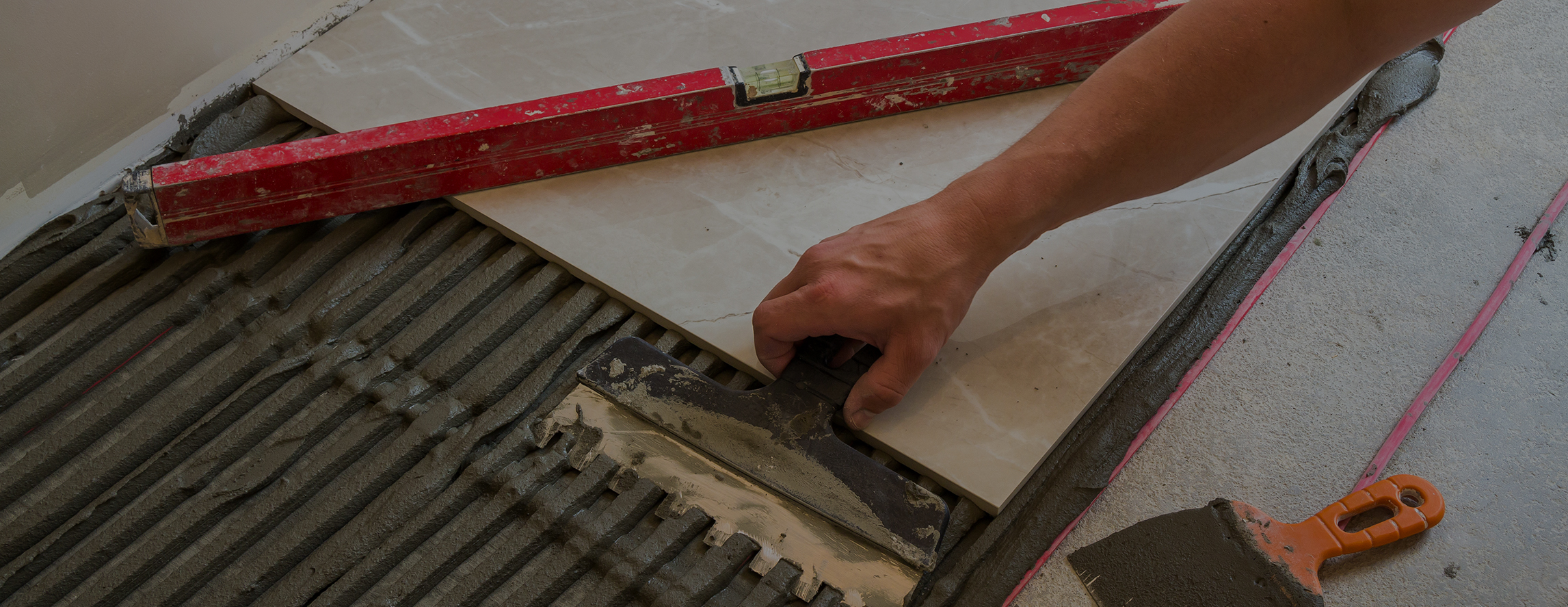 Large tile being aligned during installation